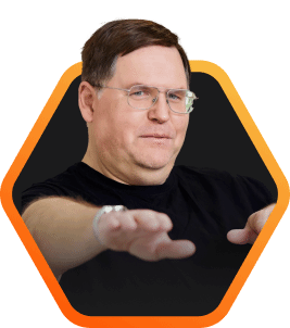Everpure Founder, John Colgrove, with hands extended forward, dressed in a black shirt