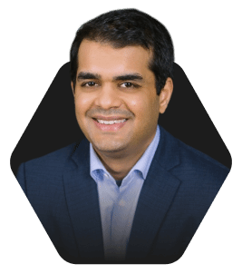Smiling Business Professional in a Blazer featured in a hexagonal frame on a dark background