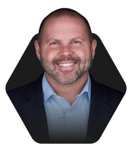 Smiling man in a cap with a welcoming expression featured in a hexagonal frame on a dark background