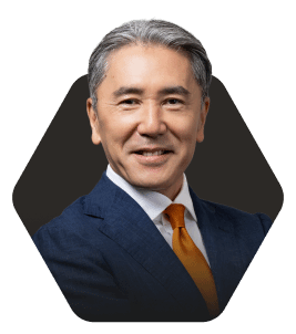 Professional Headshot with a Warm Smile featured in a hexagonal frame on a dark background