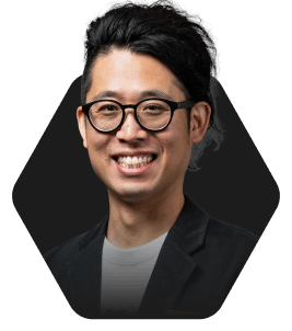 Professional Headshot with a Warm Smile featured in a hexagonal frame on a dark background