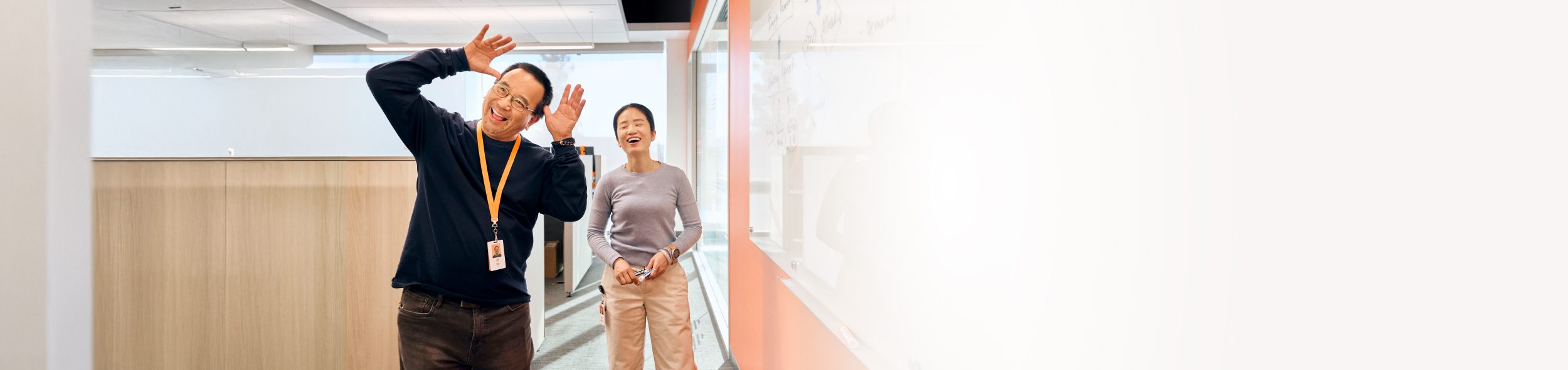 Two individuals engaged in a discussion in a modern office environment