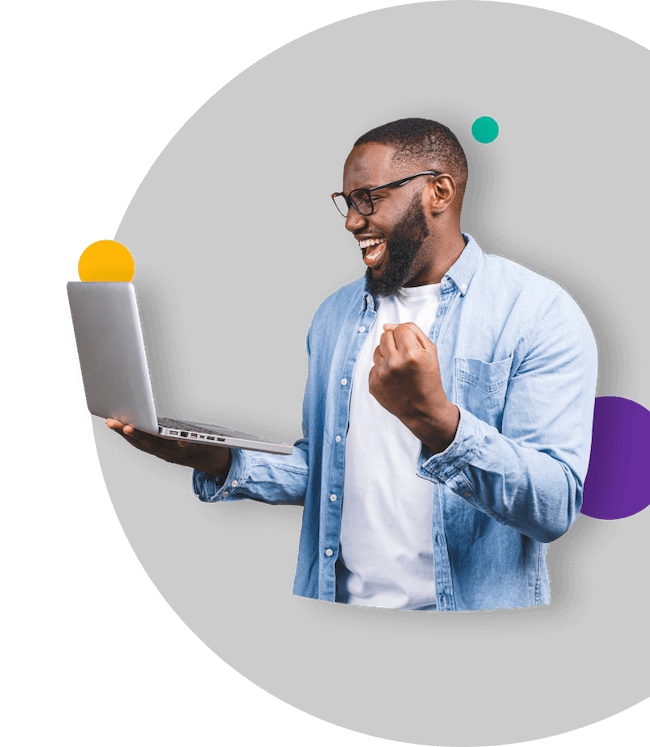 Excited man celebrating success while using a laptop
