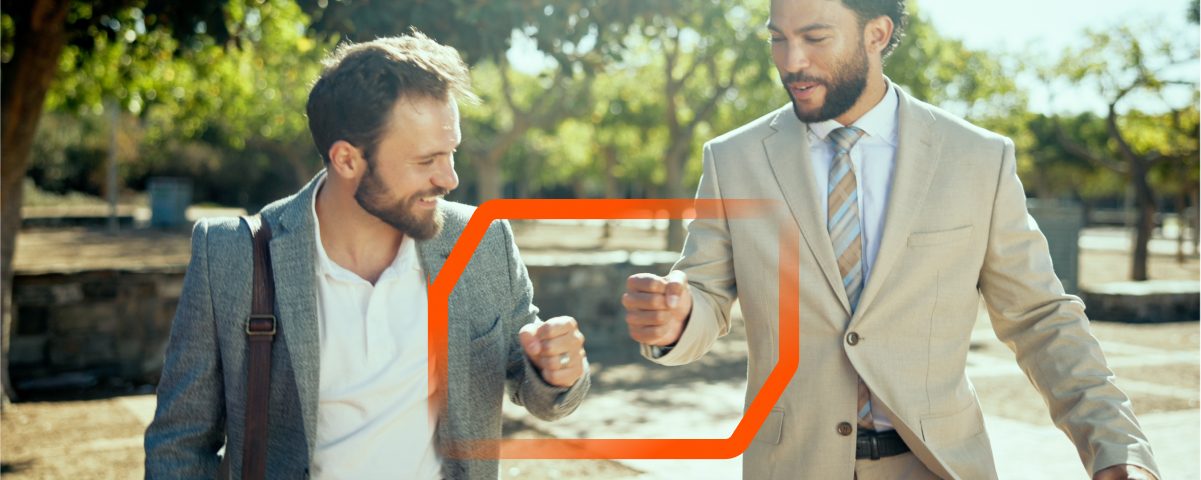 Two men enjoying a friendly interaction in a sunny setting