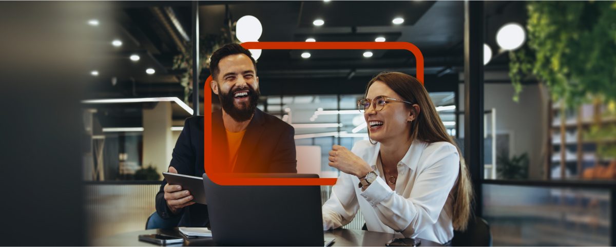 Colleagues enjoying a lighthearted moment during a meeting in a modern workspace