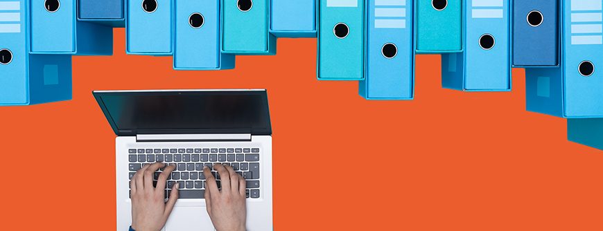 Organized archive with ring binders and woman searching for files in the database using a laptop, top view; Shutterstock ID 1029020020; purchase_order: 01; job: ; client: ; other: 